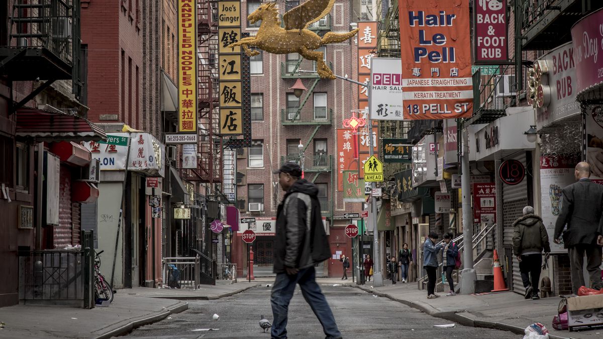 Manhattan’s Chinatown with a man in the middle of the street.