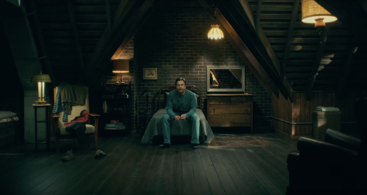 Dan Torrance (McGregor) sits on a bed.