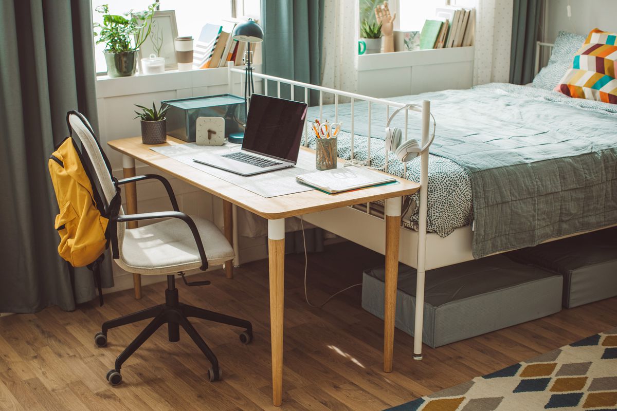 Colorful dorm room with desk and bed
