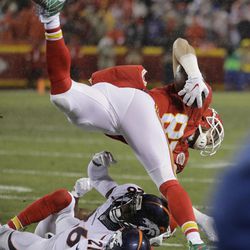 Kansas City Chiefs tight end Travis Kelce (87) jumps over Denver Broncos cornerback Aqib Talib (21) and safety Darian Stewart (26) during the first half of an NFL football game in Kansas City, Mo., Sunday, Dec. 25, 2016. 