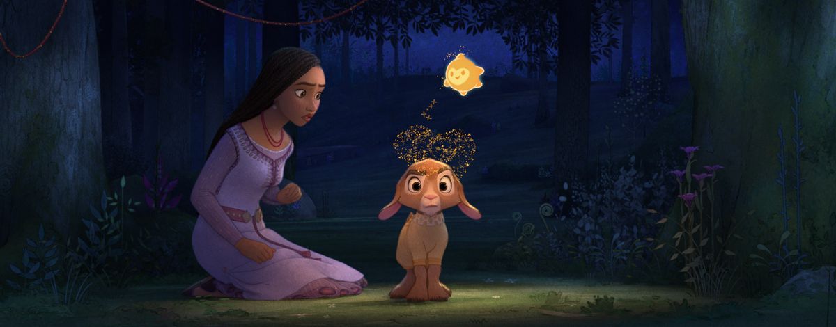 Asha (voiced by Ariana DeBose) looks at her pajama-wearing goat Valentino (voiced by Alan Tudyk) as Star, a small anthropomorphic star, sprinkles stardust on his head in the Disney animated movie Wish