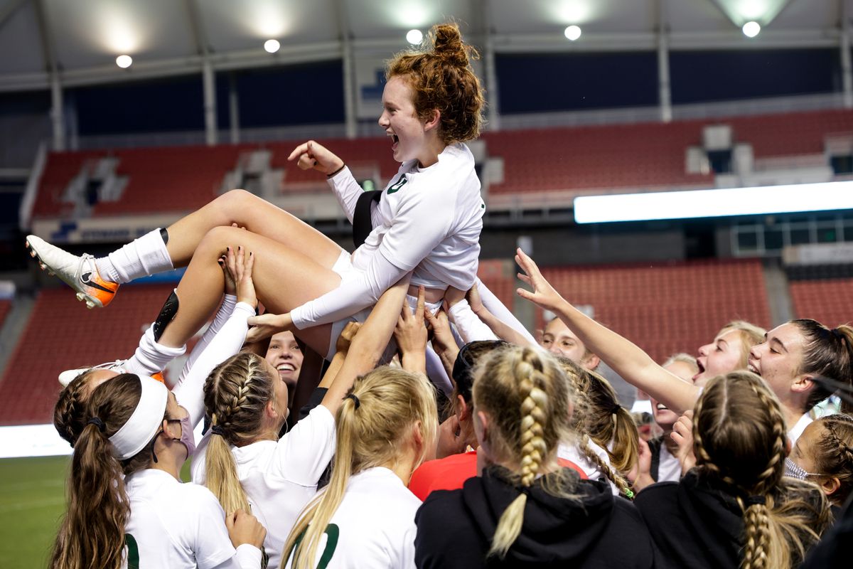 Olympus’ Emma Neff, who scored the winning goal in extra time, is lifted up as the team celebrates their win over Bonneville in the 5A girls soccer state championship at Rio Tinto Stadium in Sandy on Friday, Oct. 23, 2020.