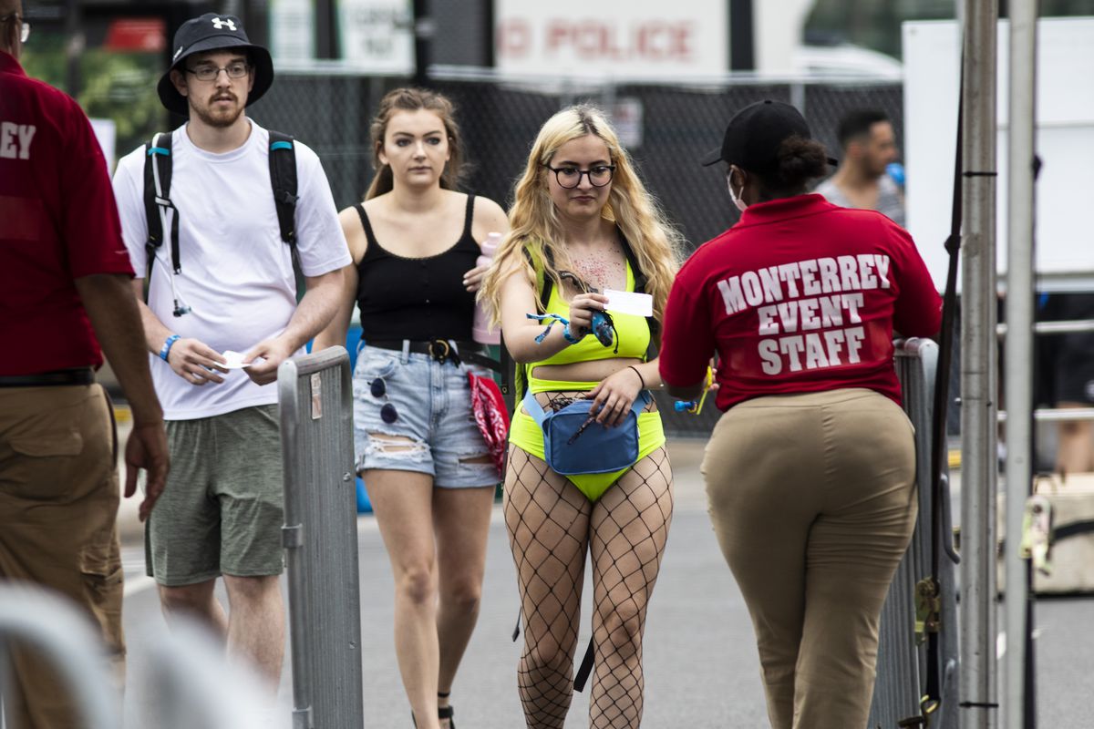Festival-goers show proof of COVID-19 vaccination as they pass through a health screening station at the main entrance on Michigan Avenue on day one of Lollapalooza in Grant Park on Thursday.