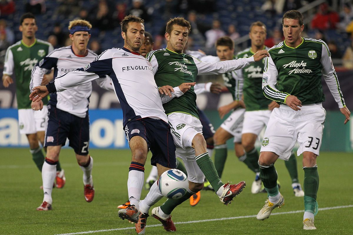 FOXBORO, MA - APRIL 2:  A. J. Soares  #5  of the New England Revolution and Eric Brunner #5 of the Portland Timbers fight for the ball at Gillette Stadium on April 2, 2011 in Foxboro, Massachusetts. (Photo by Jim Rogash/Getty Images)