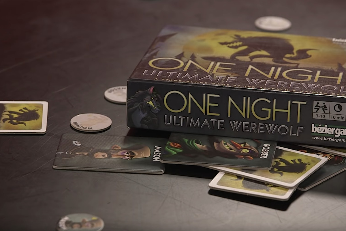One Night Ultimate Werewolf box and components on a black table