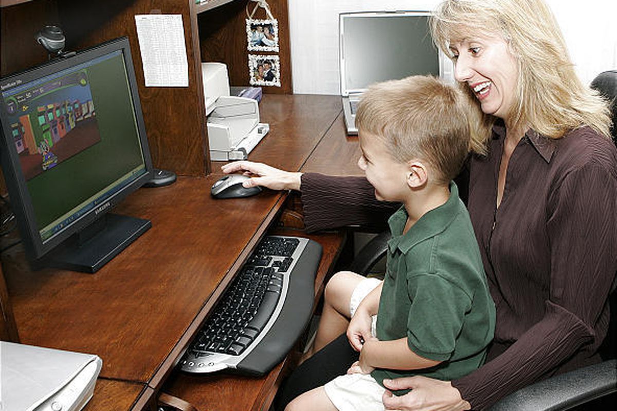 Stefanie Voss of Tallahassee, Fla., plays a game with her son Nicholas, who appears on new Web site for autism.