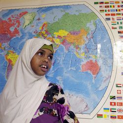 Rahma Hassan stands near a world map at the Sunnyvale Neighborhood Center in Millcreek on Friday, March 29, 2013.