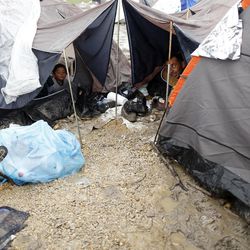 Migrants rest in an improvised camp on the border line between Macedonia and Serbia near the northern Macedonian village of Tabanovce, Friday, March 11, 2016.  About 1,500 refugees remain stranded at the Macedonian border with Serbia as the borders on the Balkan migrant route are closing. 