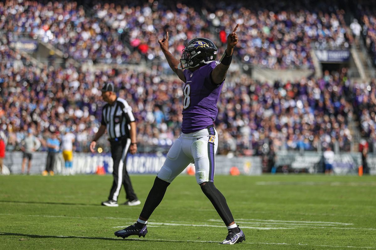 Quarterback Lamar Jackson #8 of the Baltimore Ravens celebrates a touchdown scored by Le’Veon Bell #17 (not pictured) during the second quarter against the Los Angeles Chargers at M&amp;T Bank Stadium on October 17, 2021 in Baltimore, Maryland.