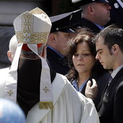 Boston Cardinal Sean O'Malley comforts Patty Campbell and her son, Billy, after a  funeral for her daugher, Krystle Campbell, 29, at St. Joseph's Church in Medford, Mass. Monday, April 22, 2013. Krystle Campbell is one of three victims killed in the Boston Marathon explosions. (AP Photo/Elise Amendola)