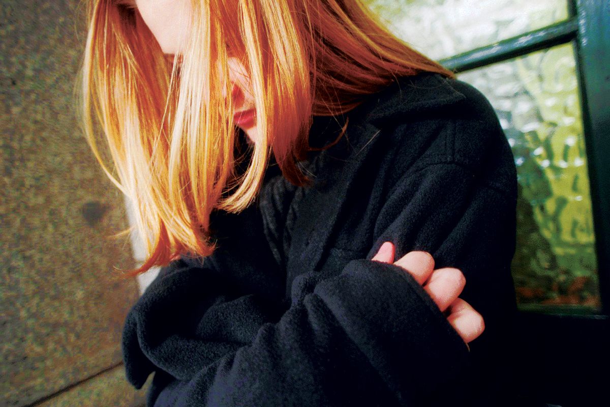A young girl holds herself for sescurity, 24 June 1998. THE AGE Picture by ANGE
