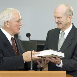 Marlin K. Jensen, church historian for the Church of Jesus Christ of Latter-day Saints (left), presents a copy of the Joseph Smith Papers to Elder Russell M. Nelson of the Quorum of the Twelve Apostles during a press conference introducing a volume of the Joseph Smith Papers Project September 22, 2009 in Salt Lake City, Utah.
