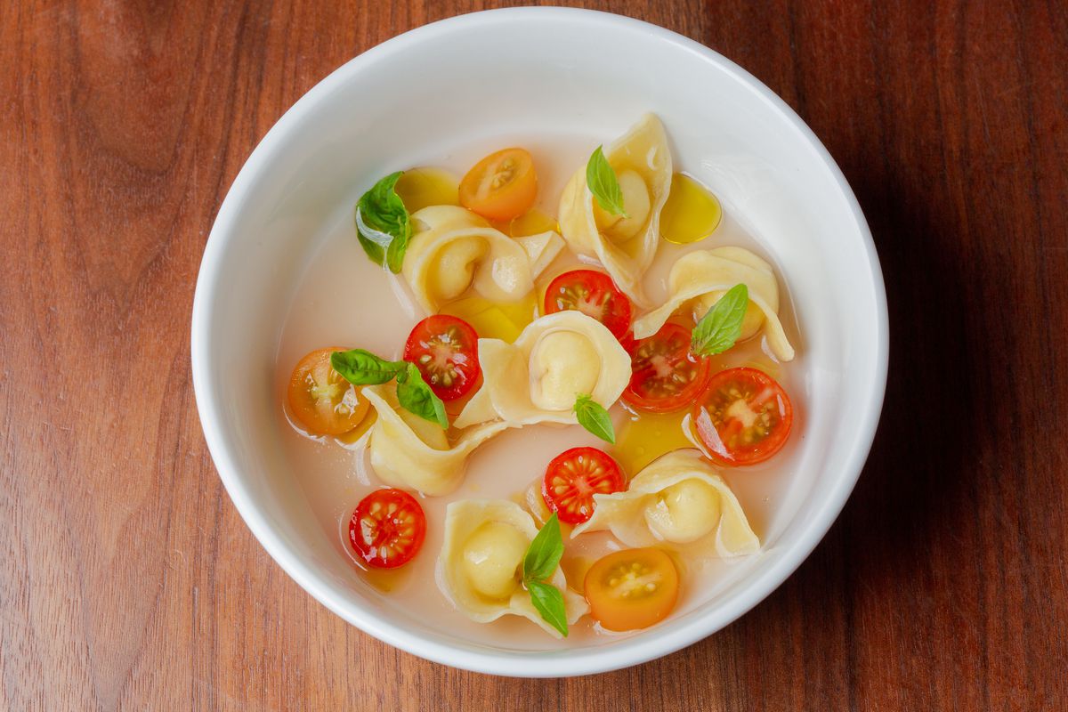 Tortellini and tomatoes with basil in a light broth