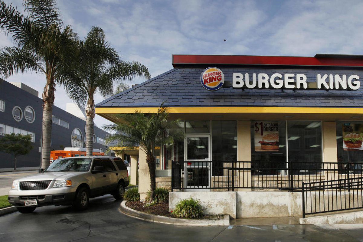 In this Thursday, April 25, 2013, photo, a car stops at the drive-thru at a Burger King restaurant near downtown Los Angeles. Burger King reports their quarterly earnings on Friday, April 26, 2013. 