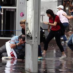 A man falls injured as Turkish riot police spray water cannon at demonstrators who remained defiant after authorities evicted activists from an Istanbul park, making clear they are taking a hardline against attempts to rekindle protests that have shaken the country, in city's main Kizilay Square in Ankara, Turkey, Sunday, June 16, 2013.