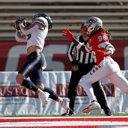 Utah State wide receiver Derek Wright, left, catches a touchdown pass in the end zone as New Mexico cornerback Corey Hightower (96) defends during the first half of an NCAA college football game on Friday, Nov. 26, 2021, in Albuquerque, N.M. 