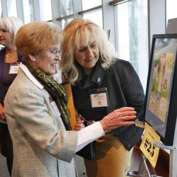 Beverly Taylor Sorenson, left, and Monica Ferguson evaluate one of 27 finalist works of art, for the SunWise with SHADE poster contest, sponsored by the U.S. Environmental Protection Agency. Winners were honored Friday, April 6, 2012, at the Huntsman Cancer Institute.