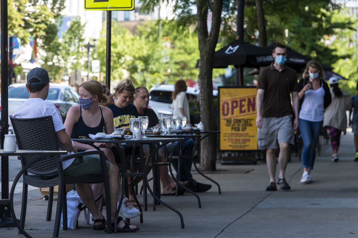 People dine on the sidewalk at Yellowtail Sushi Bar &amp; Asian Kitchen last June.