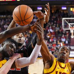 Southern California forward Chimezie Metu, and guard Shaqquan Aaron, right, reach for a rebound along with Utah forward Chris Seeley during the second half of an NCAA college basketball game, Sunday, Jan. 14, 2018, in Los Angeles. USC won 84-67. (AP Photo/Mark J. Terrill)