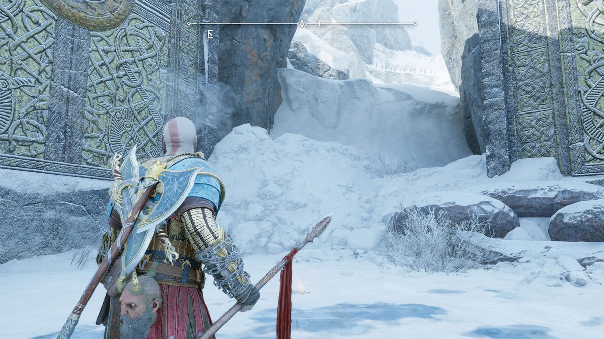 Kratos digs up some treasure in front of a big door