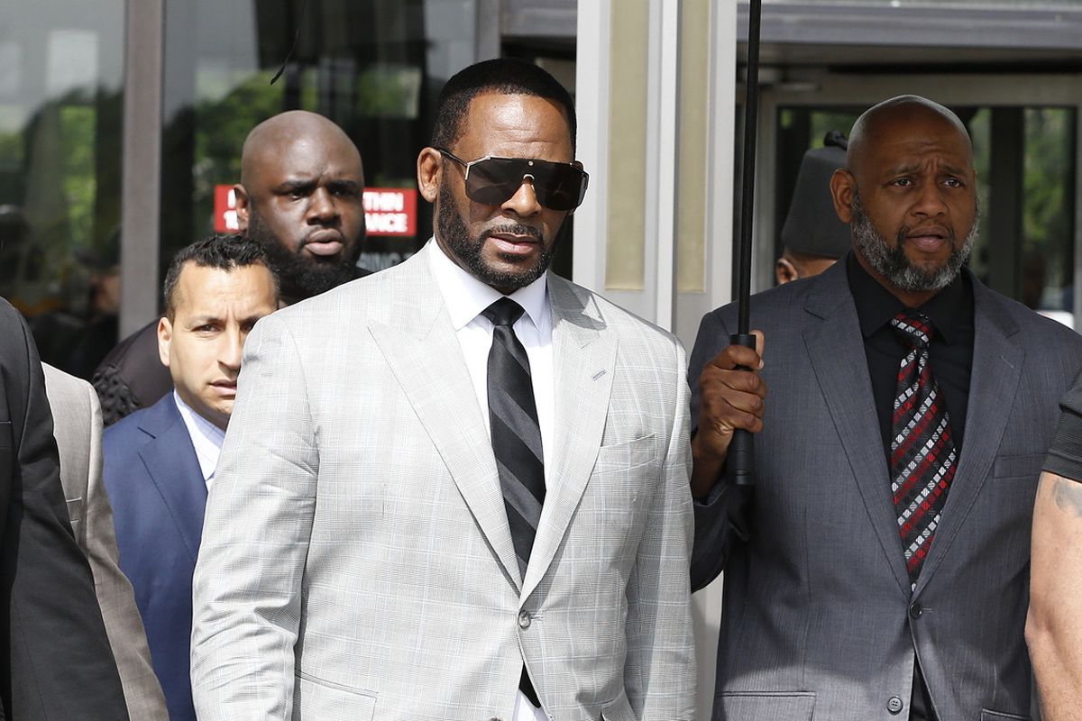 R. Kelly leaves the Leighton Criminal Court Building after appearing before a judge Thursday to face new charges of criminal sexual abuse. 