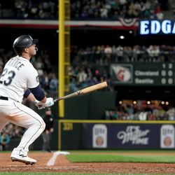 MARCH 30: Ty France #23 of the Seattle Mariners hits a three-run home run against the Cleveland Guardians during the eighth inning during Opening Day at T-Mobile Park on March 30, 2023 in Seattle, Washington.