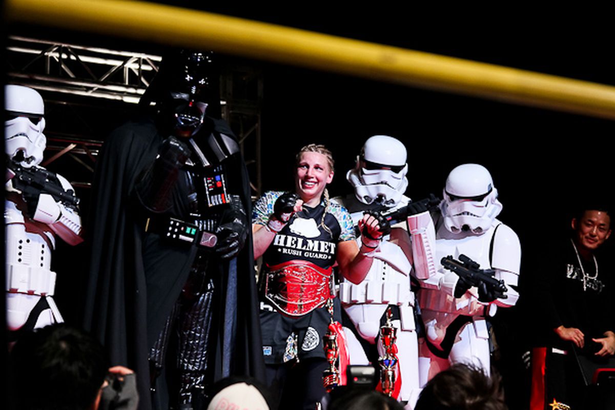 Darth Vader and Stormstroopers pose with Amanda Lucas after winning her first MMA Title at DEEP 57. <em>-- Photo by Taro Irei for <a href="http://www.sherdog.com/pictures/event/1/Pictures-Deep-57-Impact-40421" target="new">Sherdog.com</a></em>
