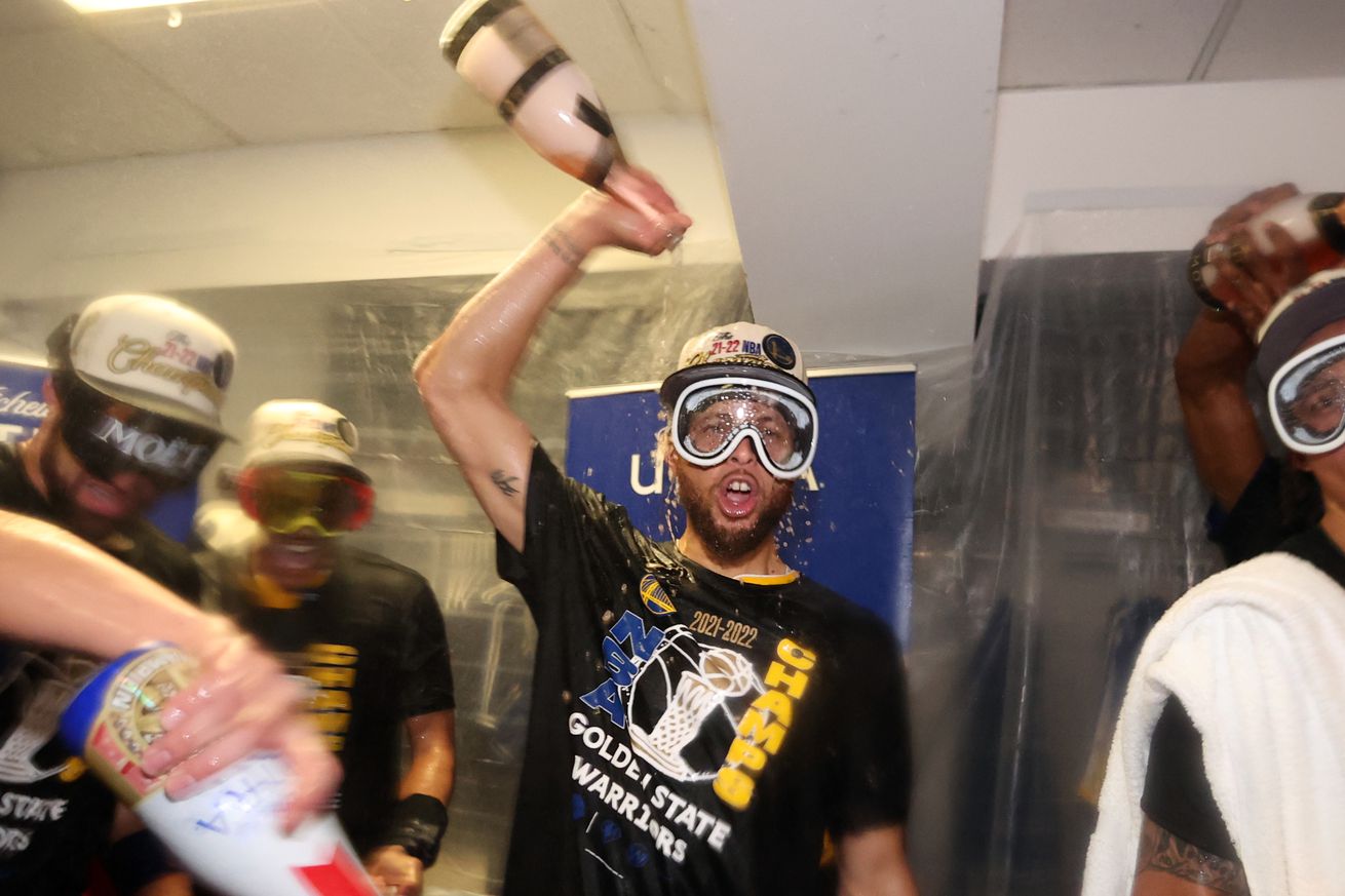 Steph Curry pouring champagne on himself 