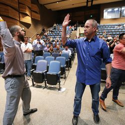 Draper residents react as Draper Mayor Troy Walker rescinds his offer of land for a homeless center during a meeting on possible sites for a homeless resource center at Draper Park Middle School on Wednesday, March 29, 2017.