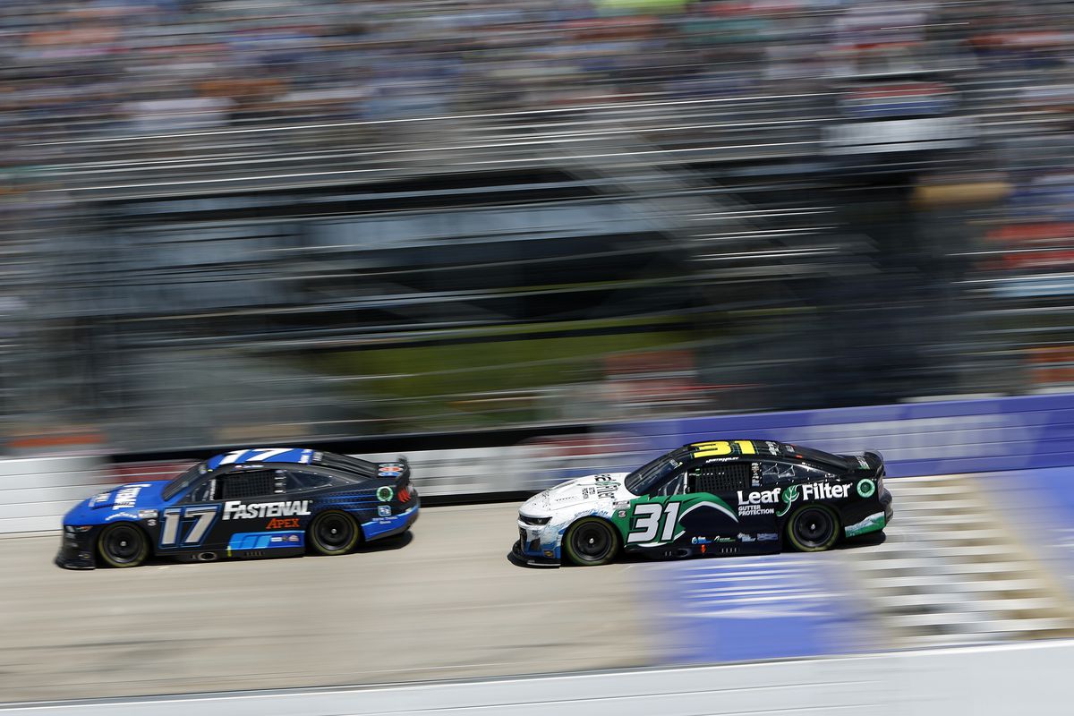 Chris Buescher, driver of the #17 Fastenal Ford, and Justin Haley, driver of the #31 LeafFilter Gutter Protection Chevrolet, race during the NASCAR Cup Series DuraMAX Drydene 400 presented by RelaDyne at Dover Motor Speedway on May 02, 2022 in Dover, Delaware.