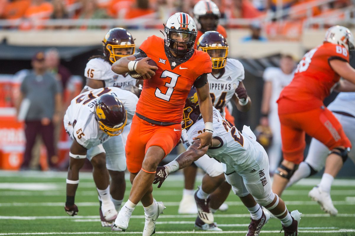 Oklahoma State Cowboys quarterback Spencer Sanders (3) runs the ball as Central Michigan Chippewas defensive back Jayden Davis (29) attempt to tackle him during the second quarter at Boone Pickens Stadium.