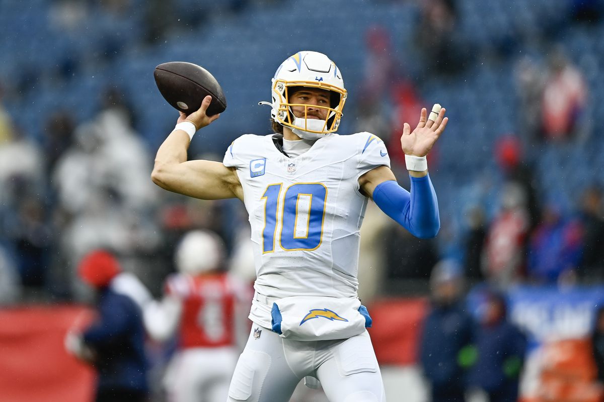 Justin Herbert of the Los Angeles Chargers warms up before the game against the New England Patriots at Gillette Stadium on December 03, 2023 in Foxborough, Massachusetts.