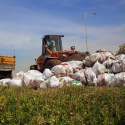 A bulldozer collects trash in Naameh suburb, south Beirut, Lebanon, Saturday, March 19, 2016. Sanitation workers have begun removing mountains of trash from the suburbs of Beirut in what residents hope marks the end of Lebanon's eight-month garbage crisis. 