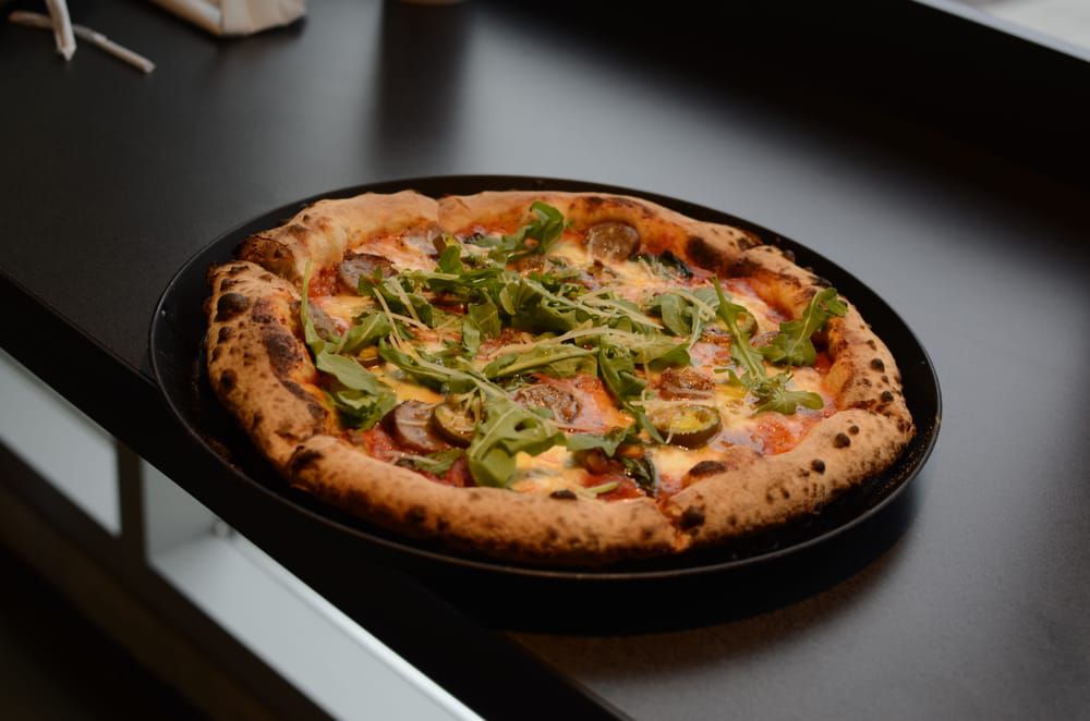 A pizza with what looks like green pepper on top