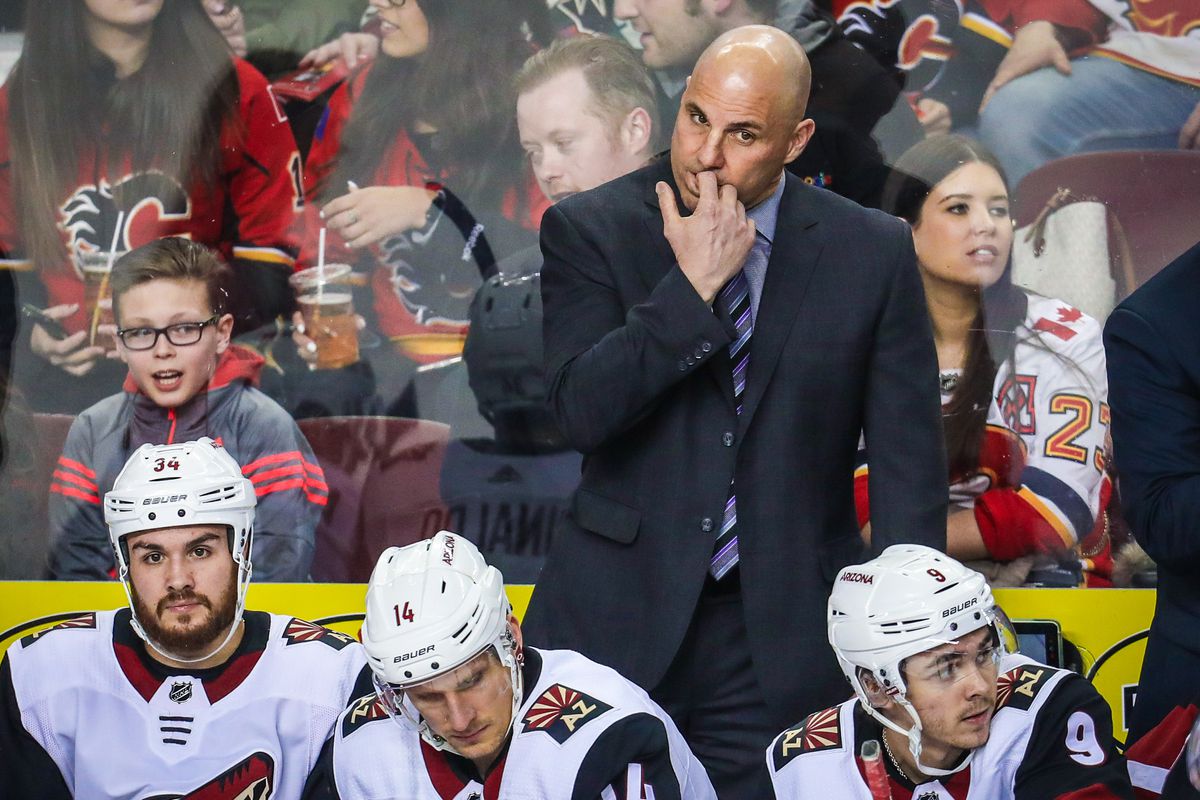 Apr 3, 2018; Calgary, Alberta, CAN; Arizona Coyotes head coach Rick Tocchet on his bench during the first period against the Calgary Flames at Scotiabank Saddledome
