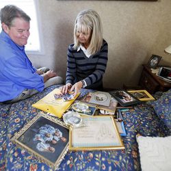 Twins Donald Dunn and Deanna Golden go through drawers of photos in their parents' home Monday, Oct. 7, 2013. Their parents, Jerry and Edith Dunn, were born the same year and died last week within hours of each other.