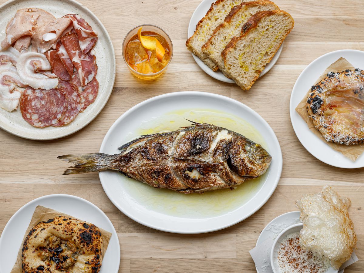 What a spread at the new Manteca might look like, featuring salumi; whole bream; and puffed pig skin