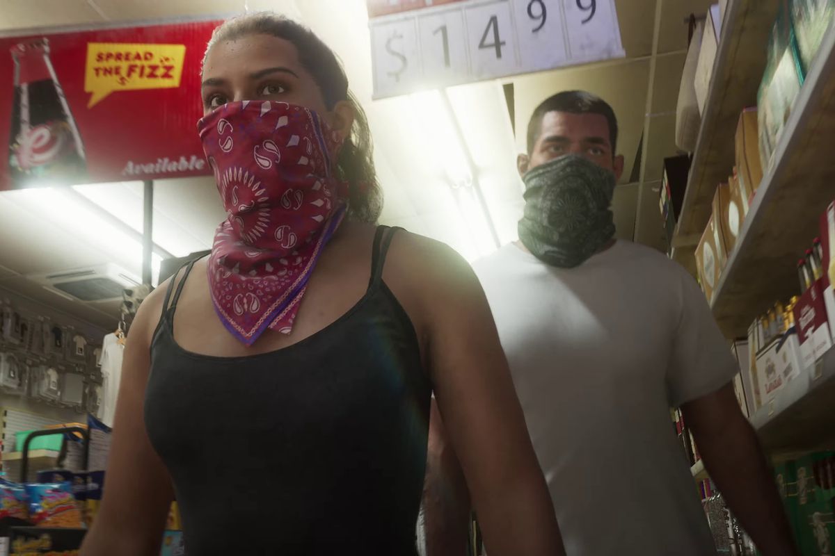 A man and a woman wearing bandanas around their faces walk through a liquor store.