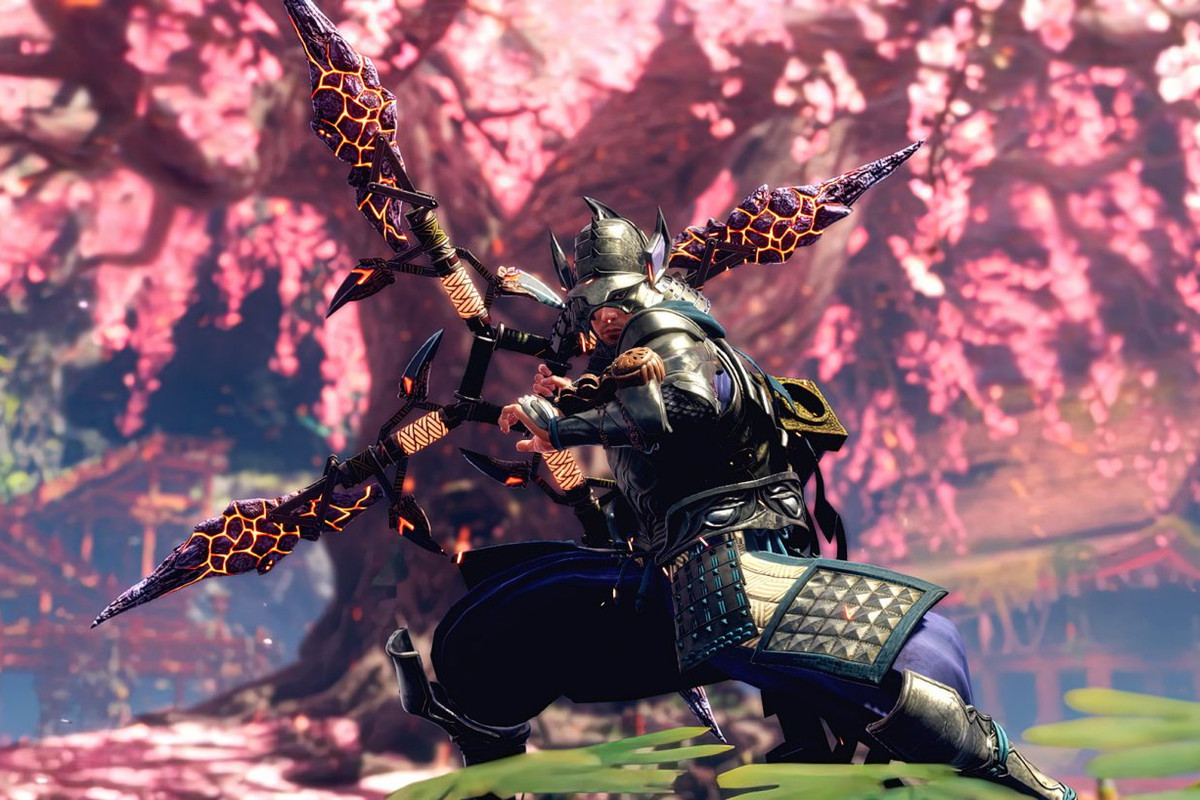 A warrior wields a weapon while looking at a tree with pink blossoms in Wild Hearts.