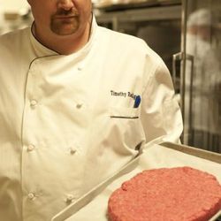 The Pub executive chef Tim Radigan shows the four-pound beef patty. 