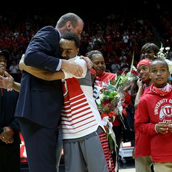 Coach Larry Krystkowiak hugs Brandon Taylor as the five seniors on the team, Taylor, Jordan Loveridge, Dakarai Tucker and Austin Eastman, along with former player and current student manager Jeremy Olsen,  were recognized before the game against the Colorado Buffaloes at the University of Utah's Huntsman Center in Salt Lake City on Saturday, March 5, 2016.  