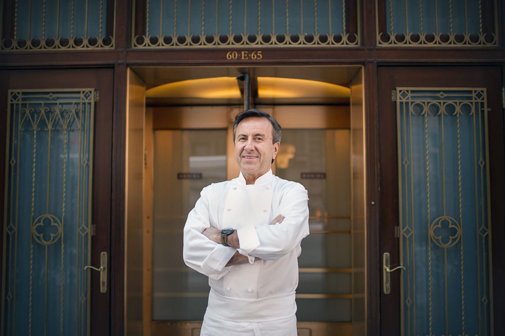 Chef Daniel Boulud stands with his arms crossed in chef’s whites.