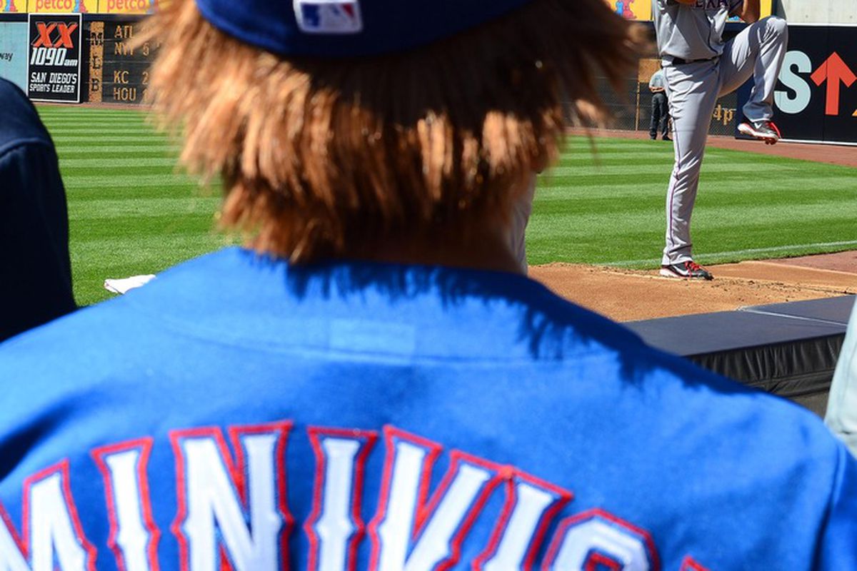 June 20, 2012; San Diego, CA, USA; A fan of Texas Rangers starting pitcher Yu Darvish (right) wearing a "Minivish" jersey watches Darvish warm-up prior to a start against the San Diego Padres at PETCO Park. Mandatory Credit: Jake Roth-US PRESSWIRE