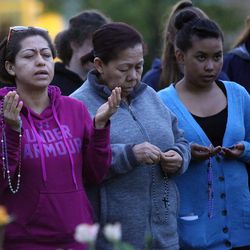 Monica Gonzalez, Thelma Ventura and Nelsy Torres join others at the Grotto of Our Lady of Guadalupe, outside of the Skaggs Catholic Center, to pray the rosary, asking for an intercession to end violence in our world in response to the mass shooting at a gay nightclub in Orlando, Florida, in Draper on Monday, June 13, 2016.