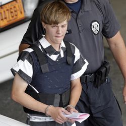 FILE - In this June 18, 2015 file photo, Charleston, S.C., shooting suspect Dylann Storm Roof is escorted from the Cleveland County Courthouse in Shelby, N.C. Prosecutors who wanted to show that Roof was a cruel, angry racist simply used his own words at his death penalty trial on charges he killed nine black people in June 2015 at a Charleston church. Roof was convicted Thursday in the chilling attack on nine black church members who were shot to death last year during a Bible study, affirming the prosecution's portrayal of a young white man who hoped the slayings would start a race war or bring back segregation.