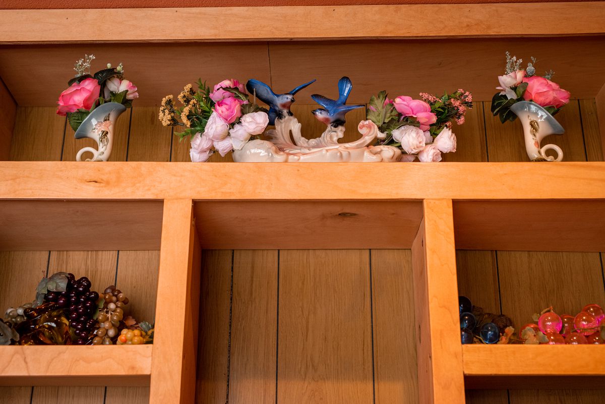 Porcelain birds on a wooden shelf.  