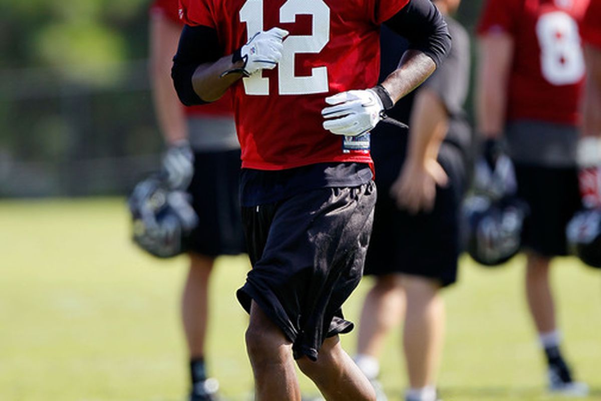 FLOWERY BRANCH GA - JULY 30:  Michael Jenkins #12 of the Atlanta Falcons runs drills during opening day of training camp on July 30 2010 at the Falcons Training Complex in Flowery Branch Georgia.  (Photo by Kevin C. Cox/Getty Images)