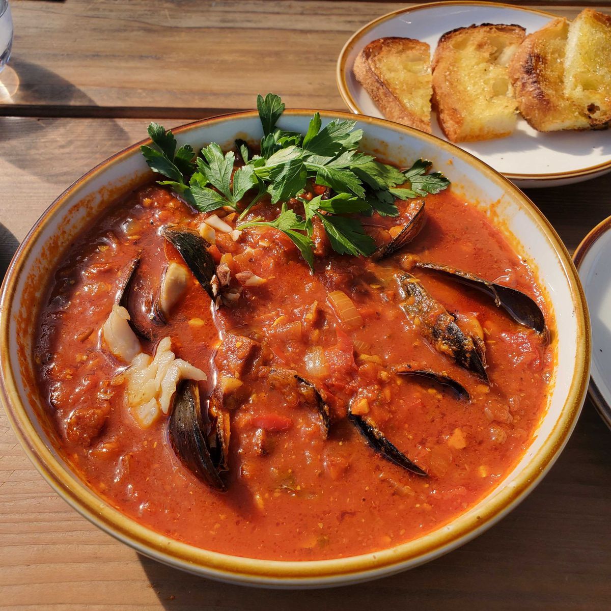 A tomato-based seafood stew in a bowl from Sailing Goat in Richmond, California.