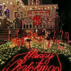 In this Dec. 14, 2016, photo, a private home in the Dyker Heights neighborhood of the Brooklyn borough of New York is elaborately decorated for Christmas. The neighborhood, world famous for it's over-the-top Christmas decorations, is drawing so many tourists that some residents are unhappy with all the attention. 