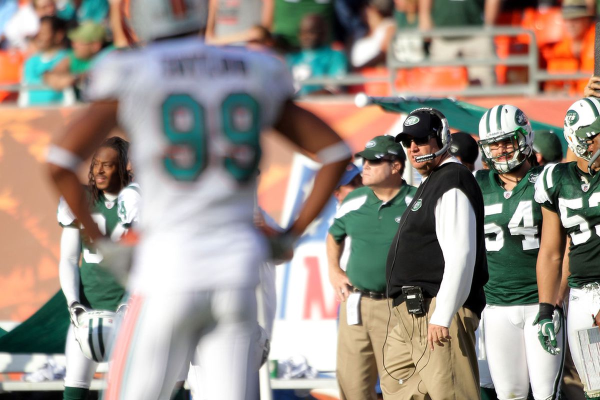 MIAMI GARDENS, FL - JANUARY 01:  Defensive end Jason Taylor #99 (L) of the Miami Dolphins stares at coach Rex Ryan of the New York Jets at Sun Life Stadium on January 1, 2012 in Miami Gardens, Florida.  (Photo by Marc Serota/Getty Images)